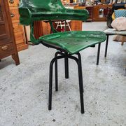 Vintage swivel workshop chair in green pressed sheet metal with a folding backrest.