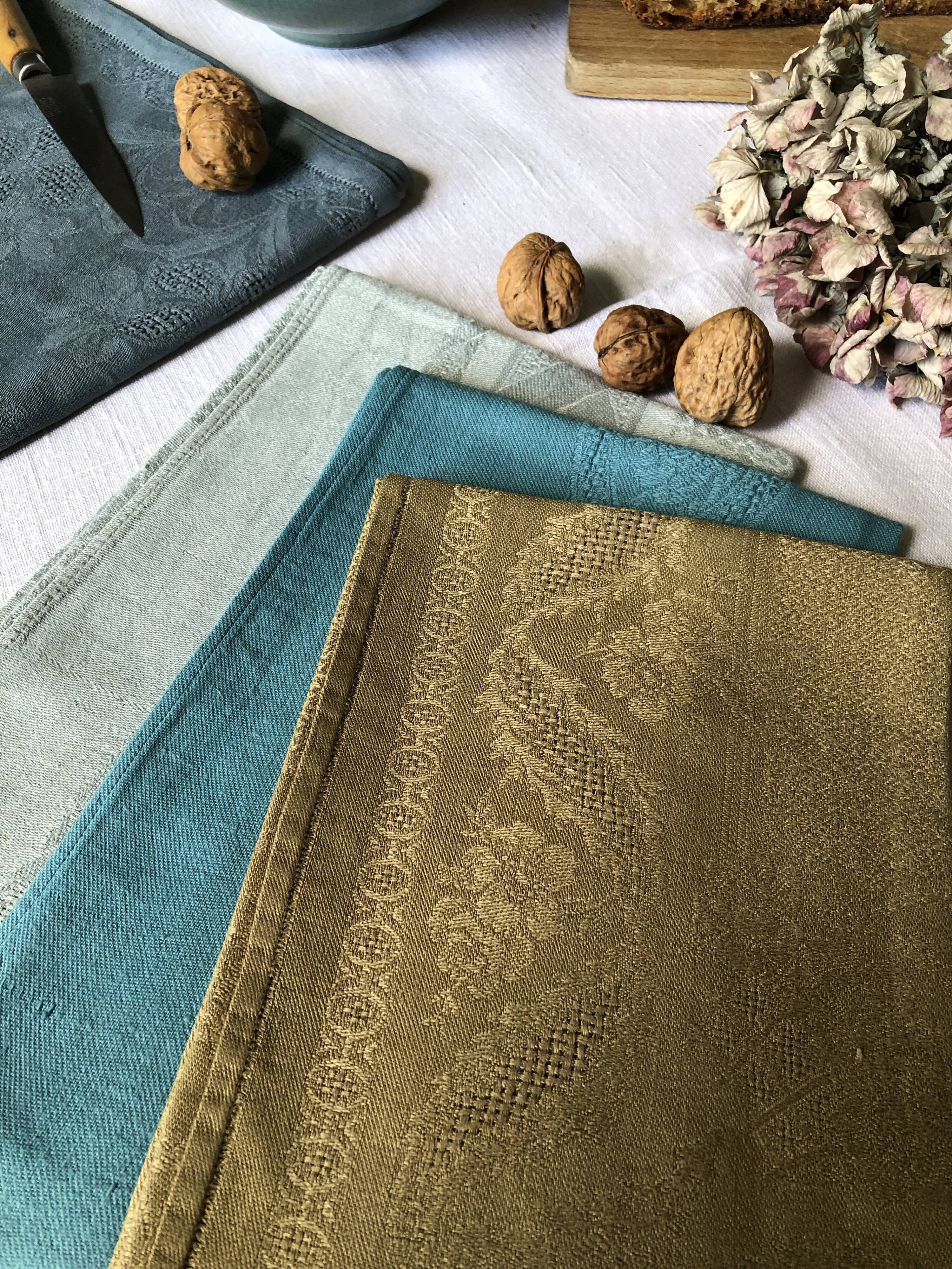 Suite of four tinted antique napkins