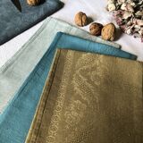 Suite of four tinted antique napkins