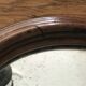 Old oval mirror with wooden frame