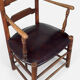 Antique rustic armchair in walnut and leather, 18th century.