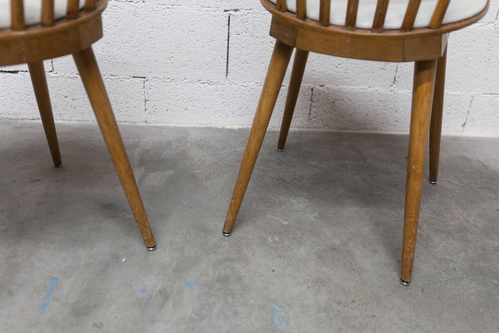 Pair of Baumann Menuet chairs, Honey patina, White skai seat