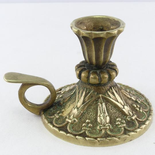 Golden bronze hand-held candlestick
