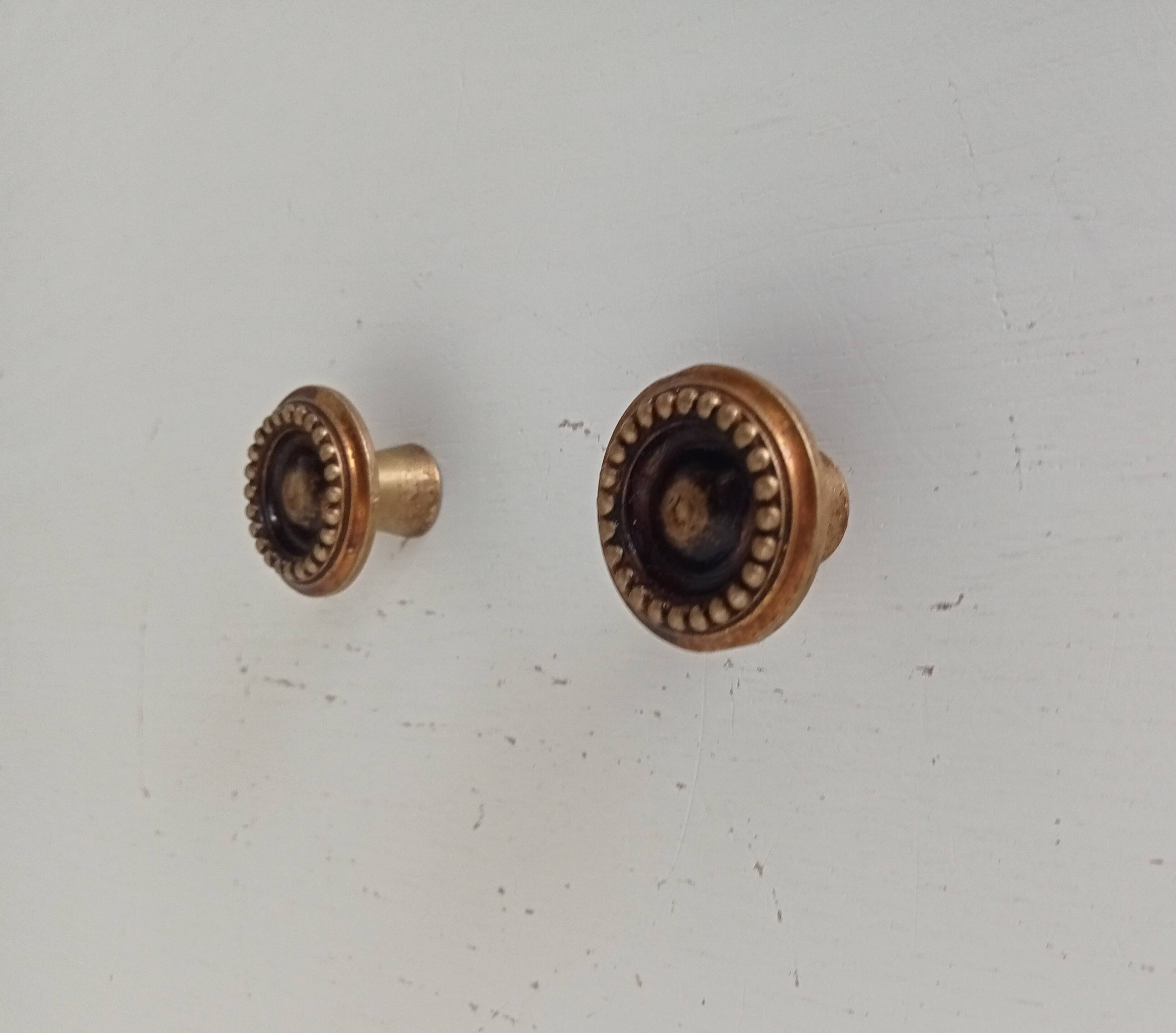 Pair of antique furniture knobs in gilded brass.