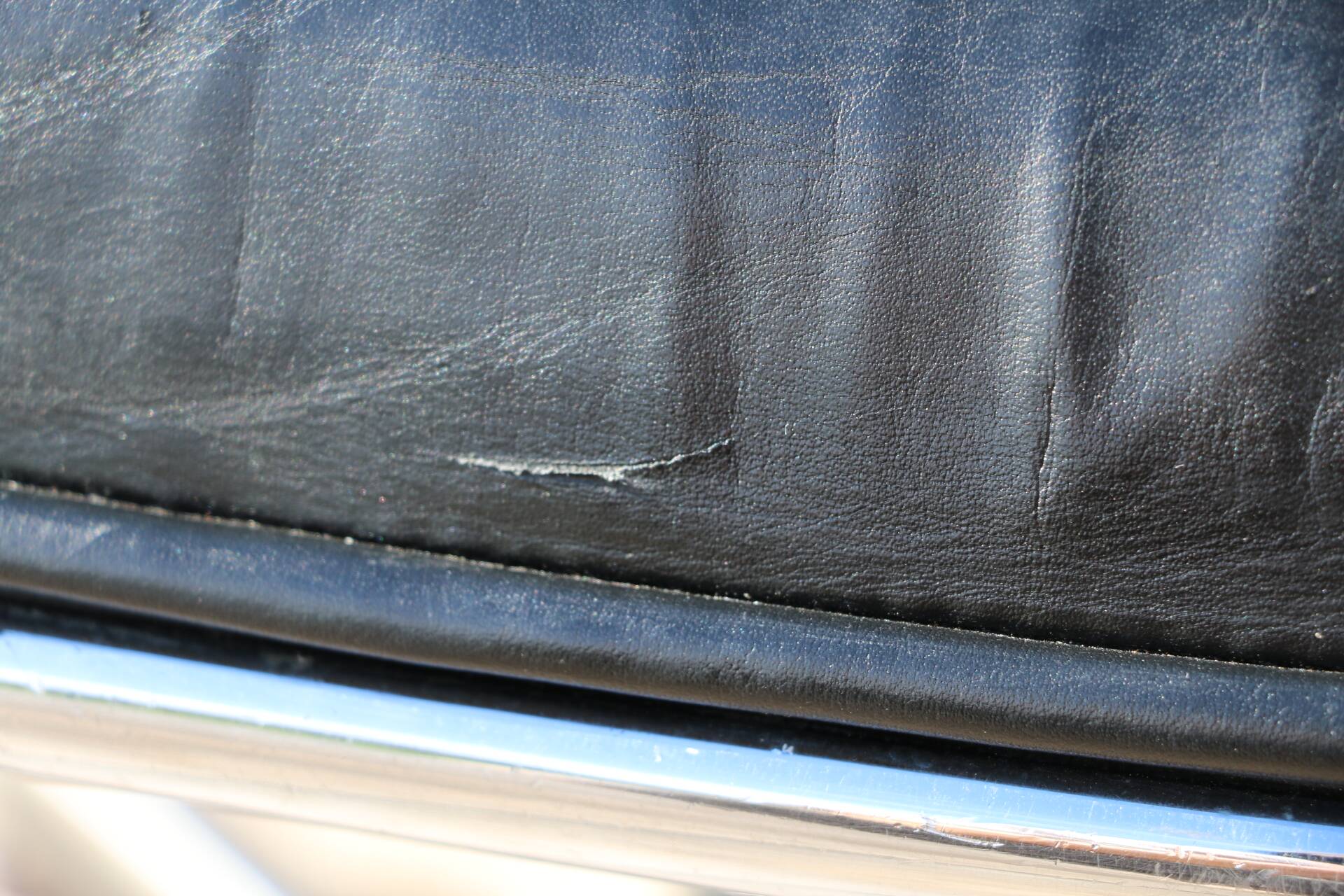 Pollock black leather reclining armchair with fixed ends