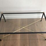 Brass coffee table upholstered in black leather. In the style of Jacques Adnet.