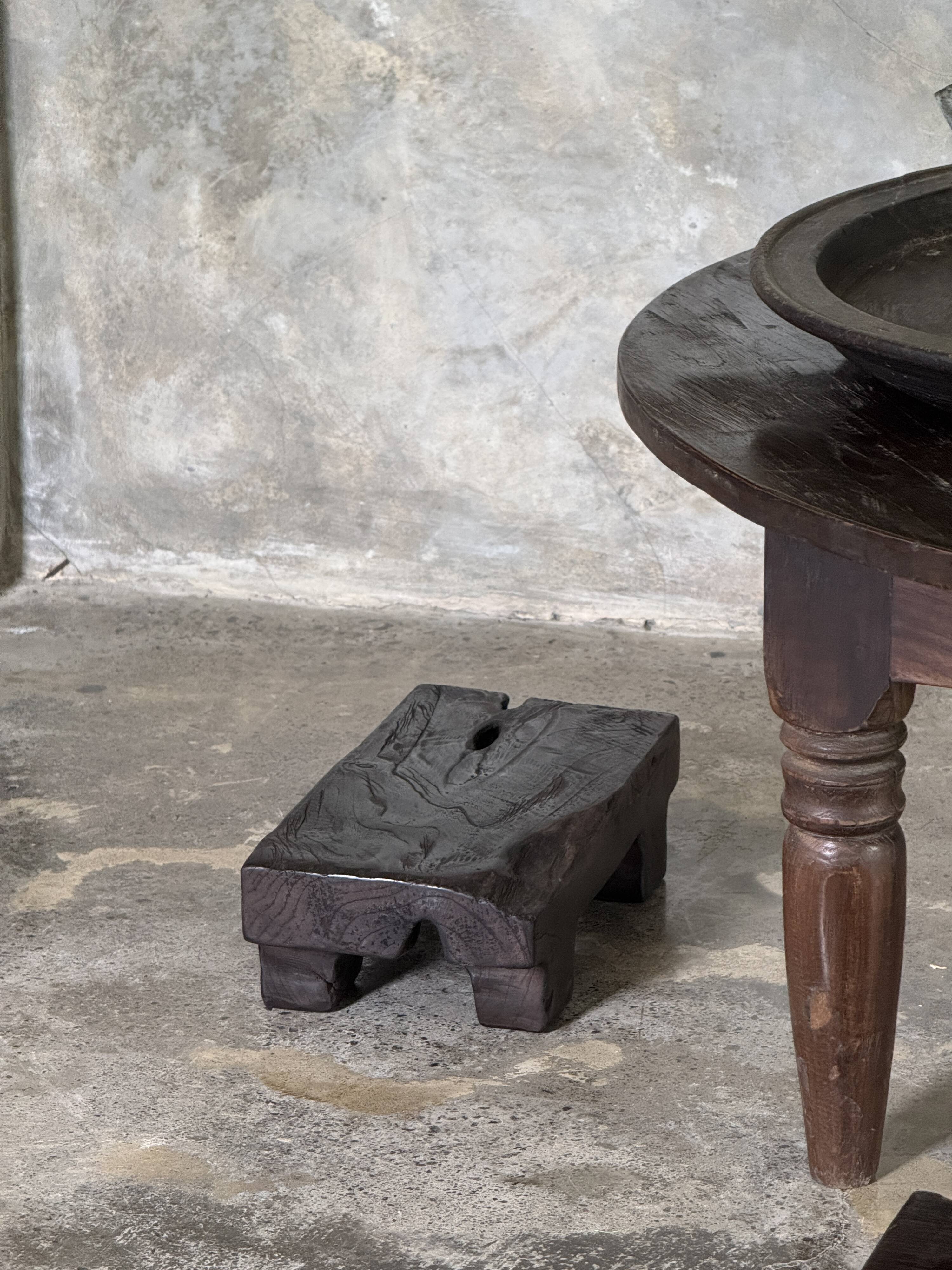Coffee table, round antique Indonesian teak table with straight legs.