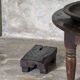 Coffee table, round antique Indonesian teak table with straight legs.