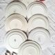 Old mismatched earthenware dessert plates with gold accompanied by a dish