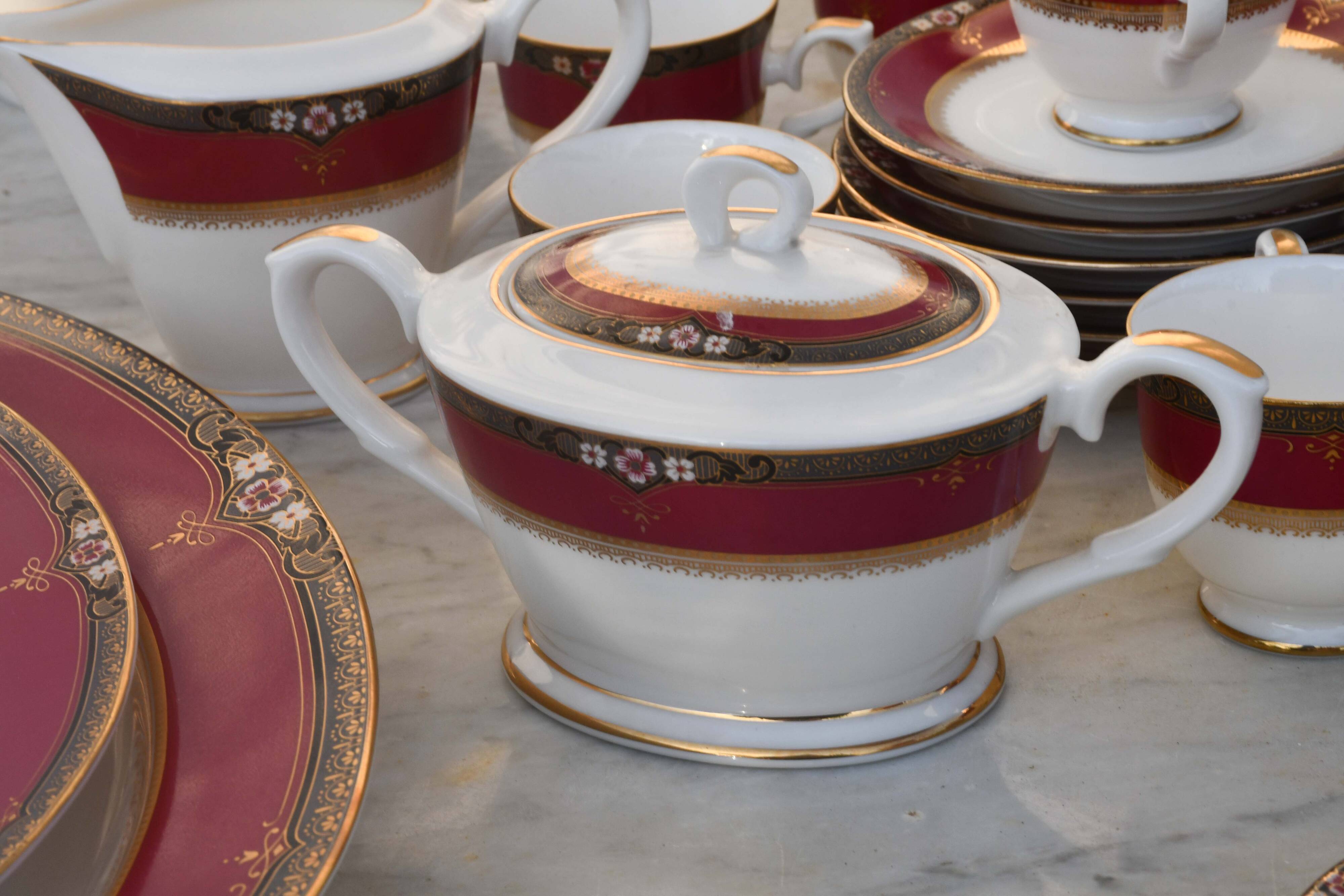 Elegant mid-century Japanese bone china service for 12 in white and noble red