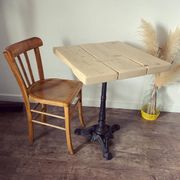Bistro table with a central cast iron base in industrial style.