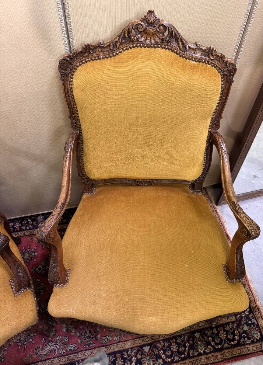 Pair of faux Louis XV armchairs in fully carved walnut