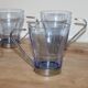 Set of 5 vintage blue-tinted glass cups with metal holders.