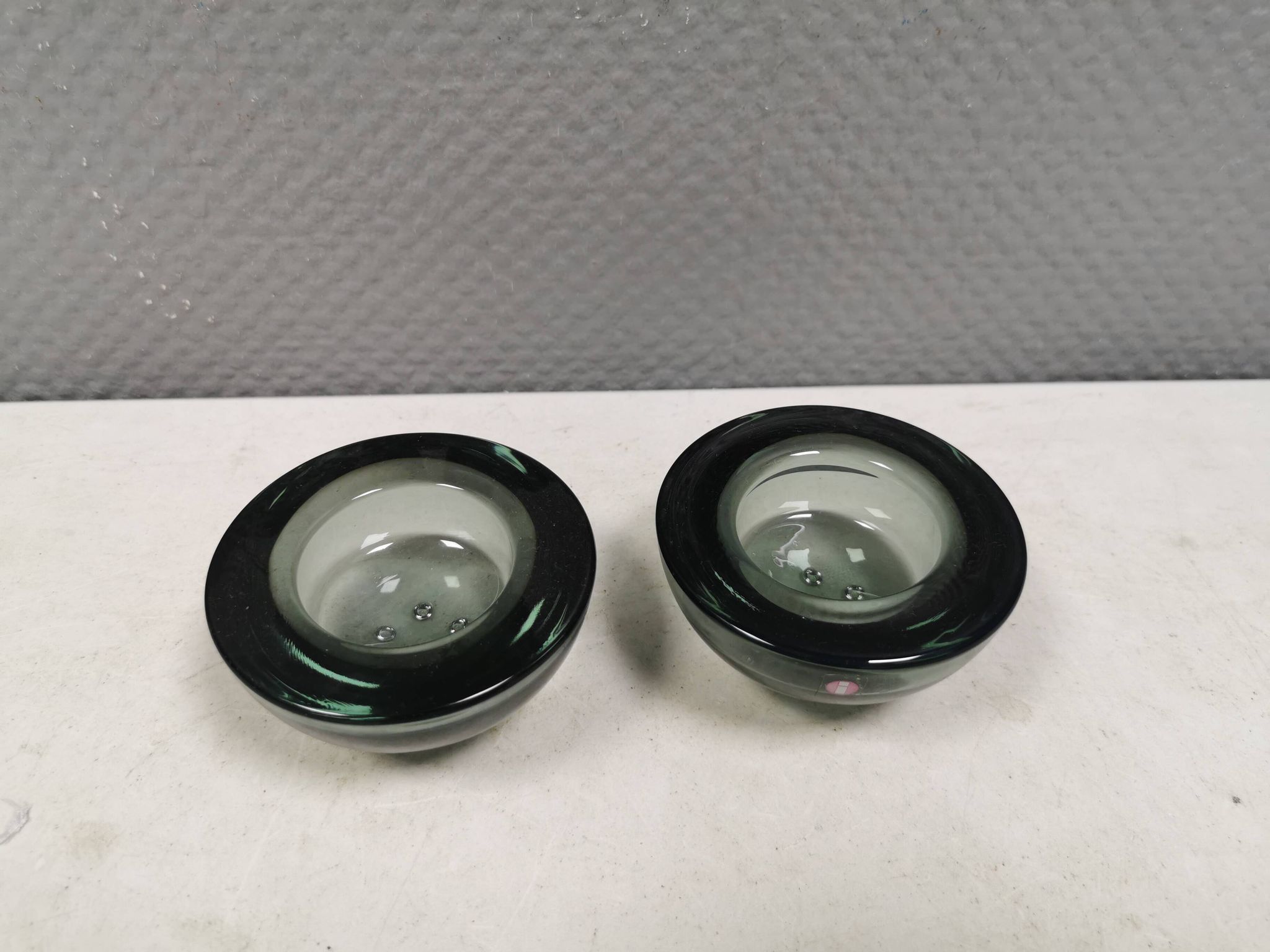 A set of iitalla candle holders in smoked transparent glass.