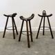 Set of 3 rustic carved oak bar stools with iron footrests, 1970s