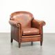 Comfortable vintage sheepskin armchair finished with decorative nails