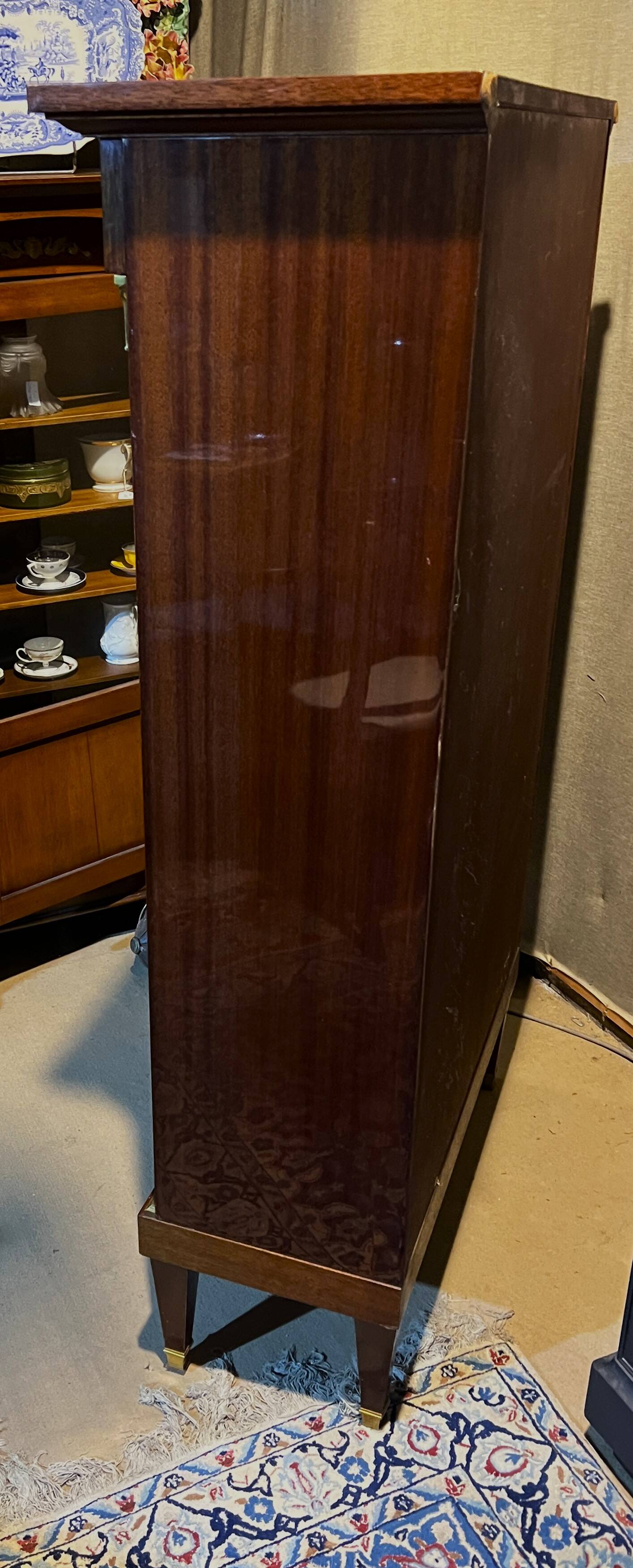 Directoire style bookcase in mahogany, decorated with gilded bronze.
