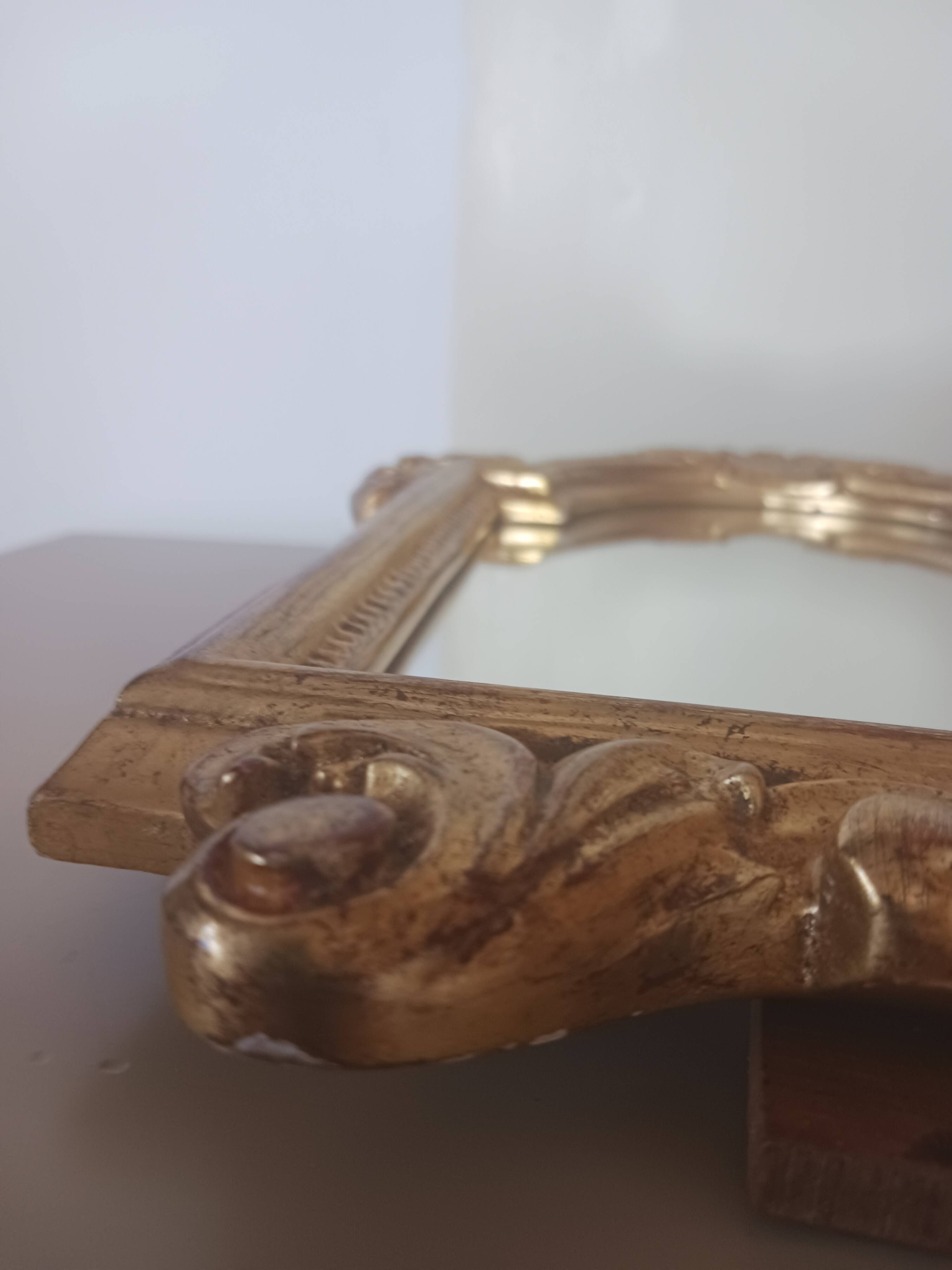 Antique mirror in gilded wood.