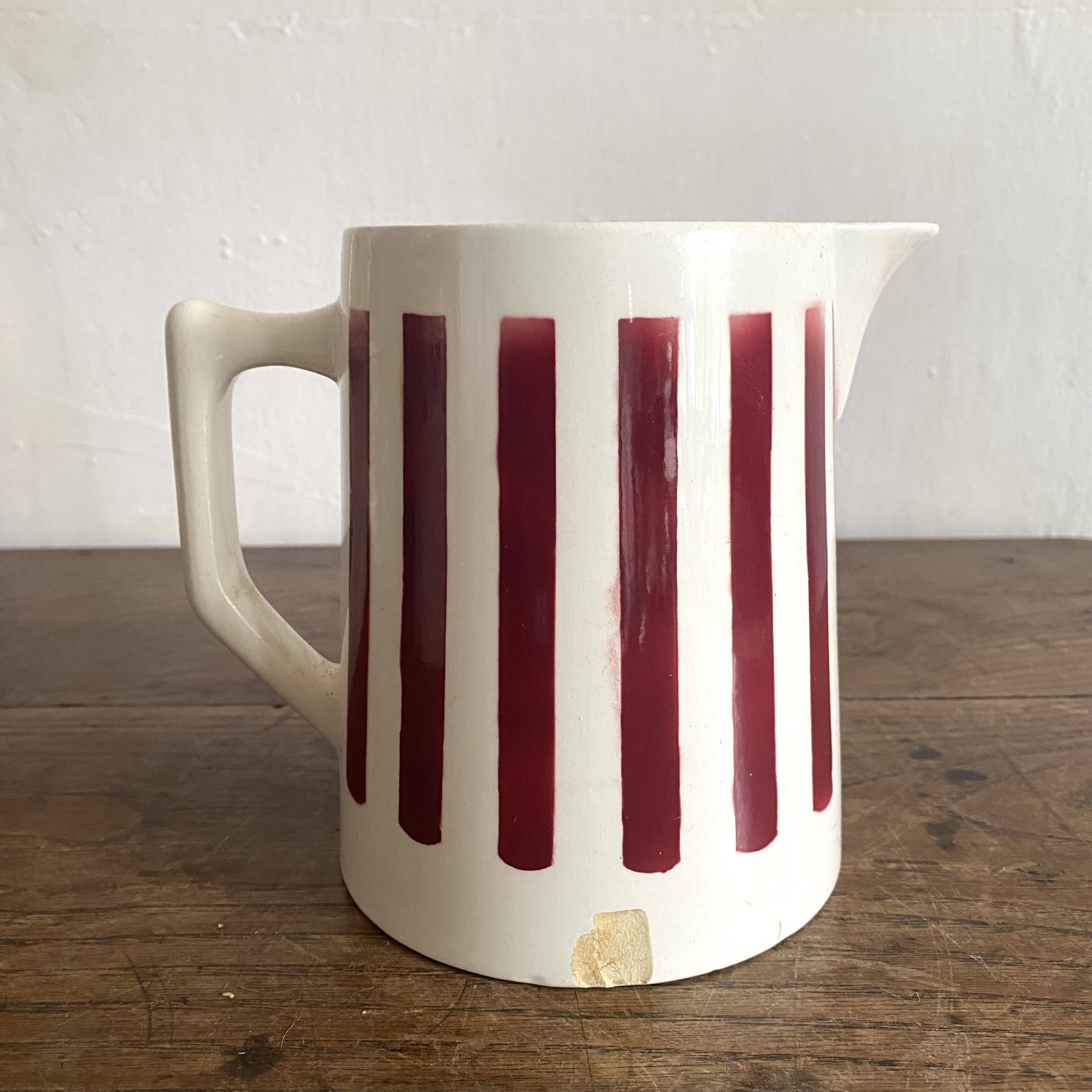 Antique earthenware pitcher with burgundy stripes