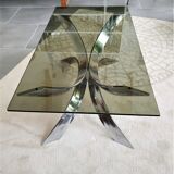 A chrome-shaped table and a 70s glass tray