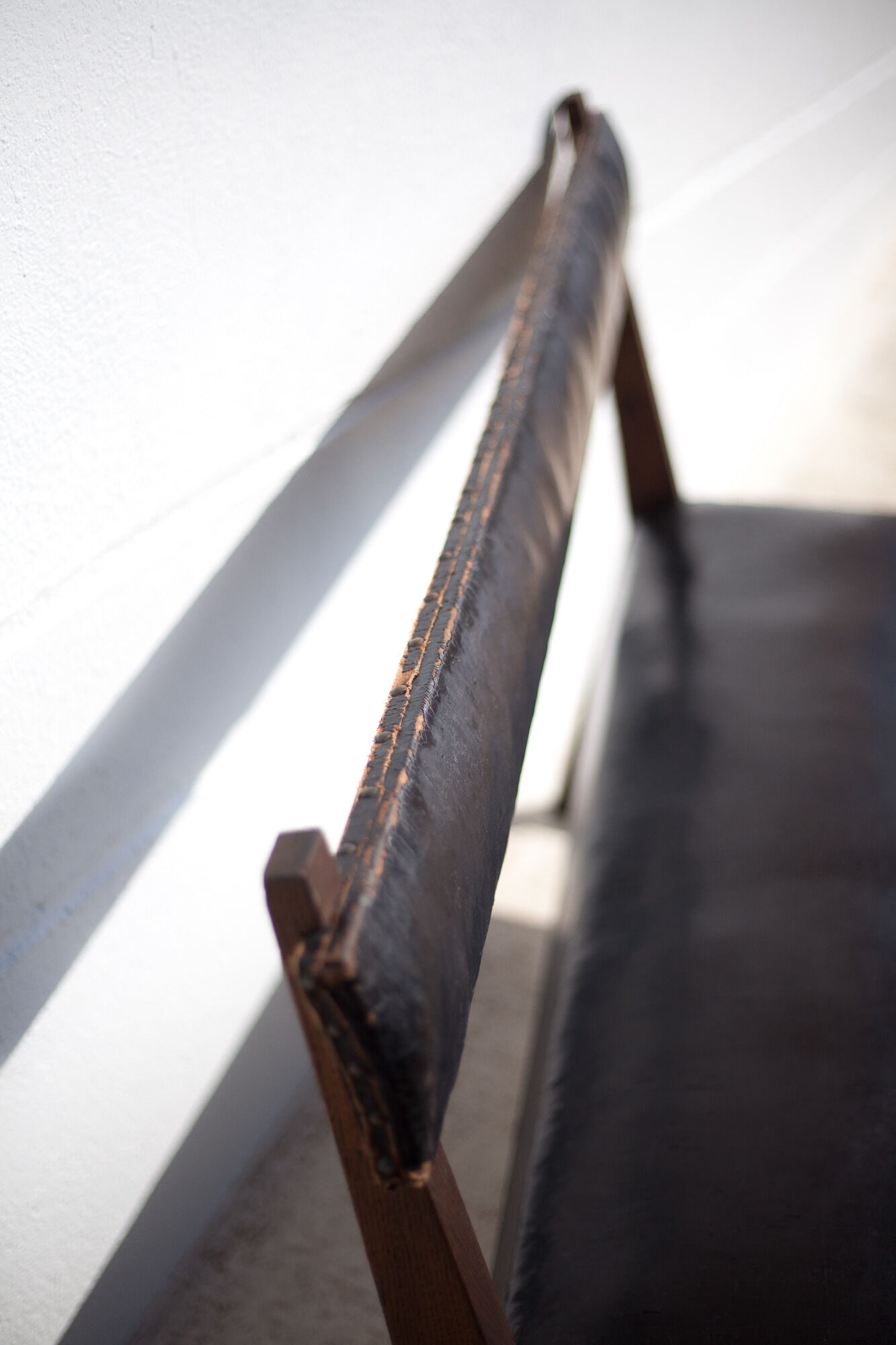 Antique wood bench and black imitation leather