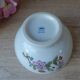 Two speckled beige ceramic breakfast bowls with pink flower decoration