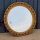 Round neoclassical style mirror in wood and gilded stucco from the 1950s