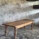 Brown Indonesian teak coffee table, with a border and cylindrical legs H40 L103.