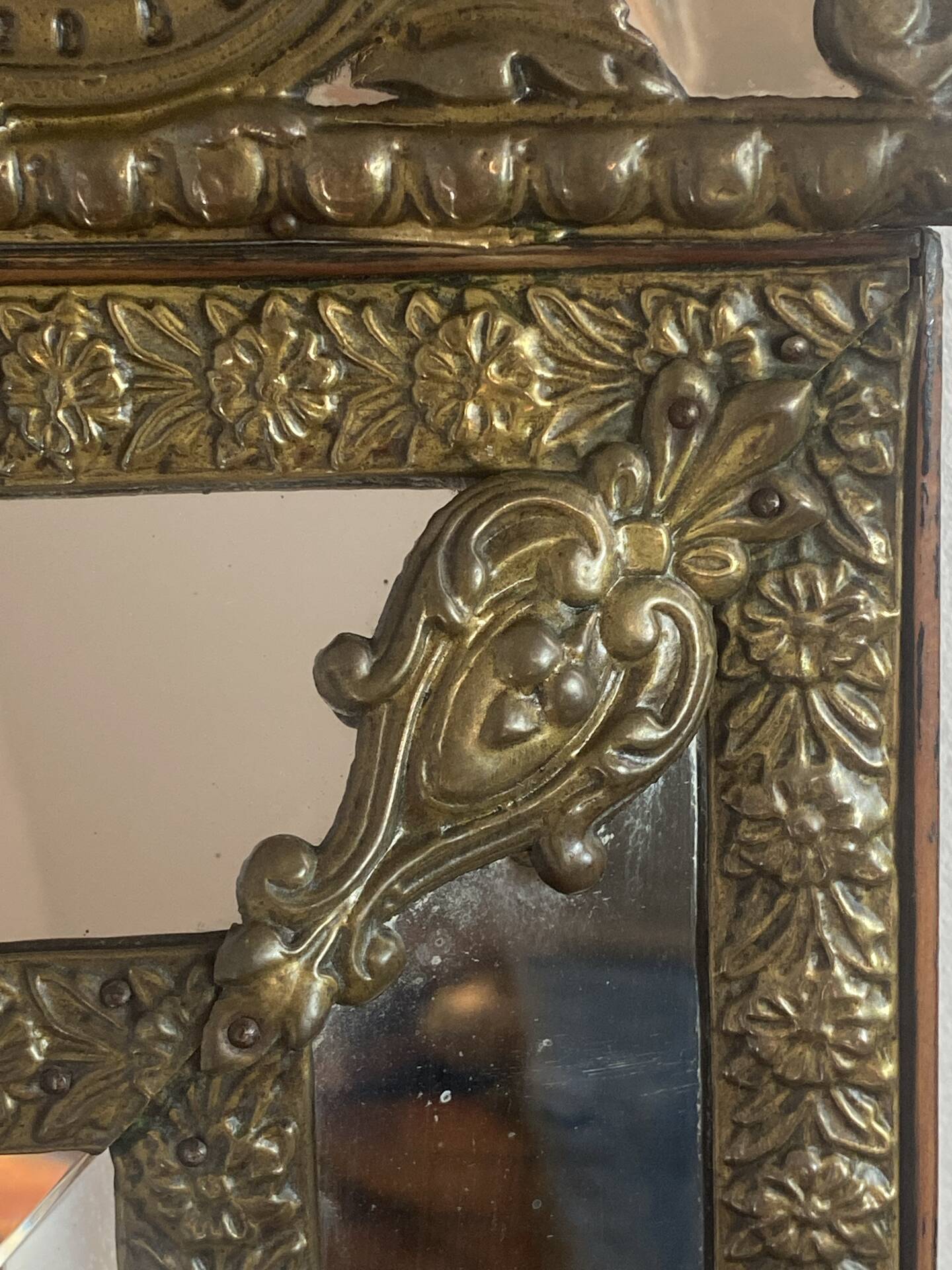 Mirror with brass repoussé frame