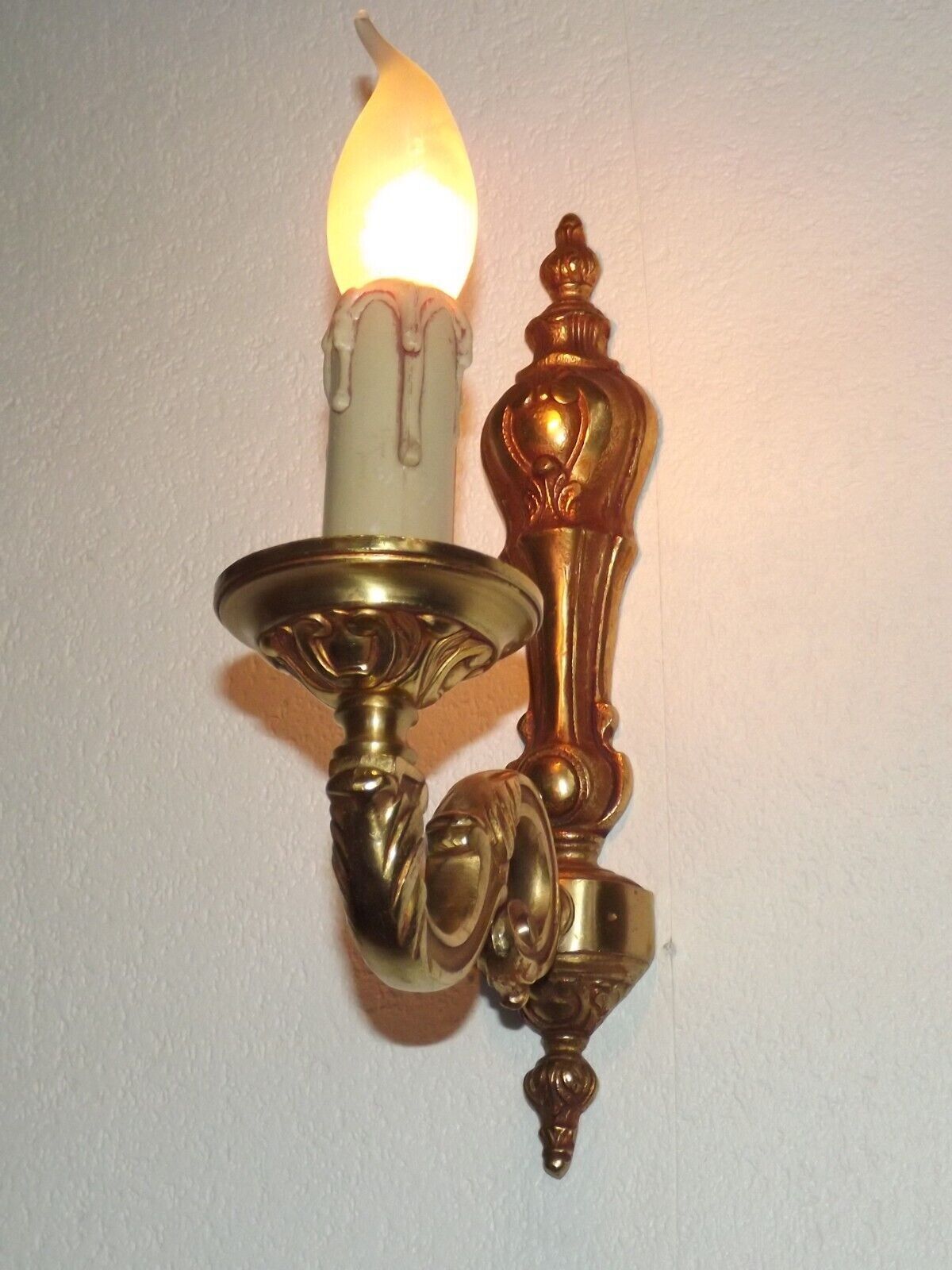 Simple wall sconce in classic Empire style in vintage French bronze.