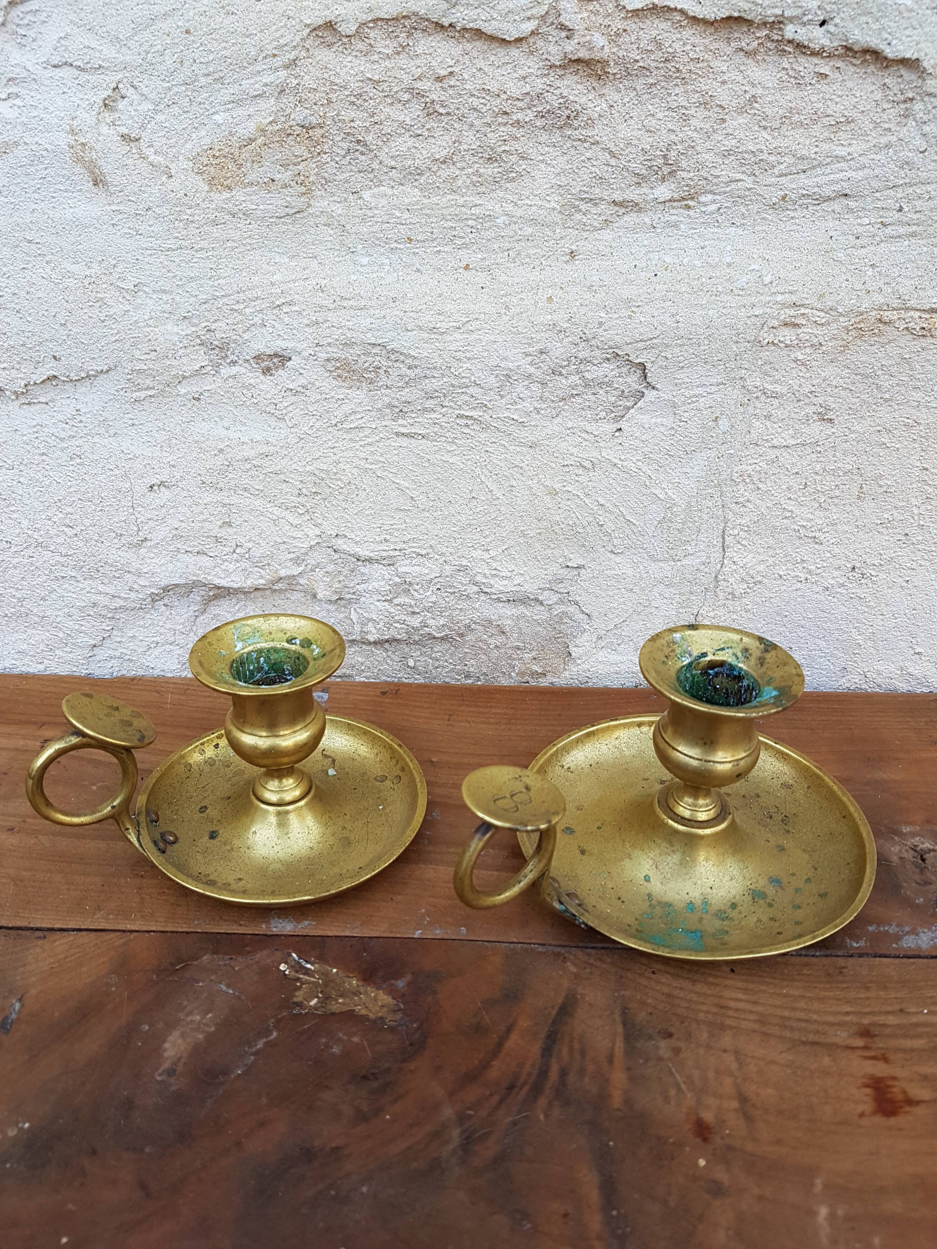 Old pair of brass candlesticks cellar rats