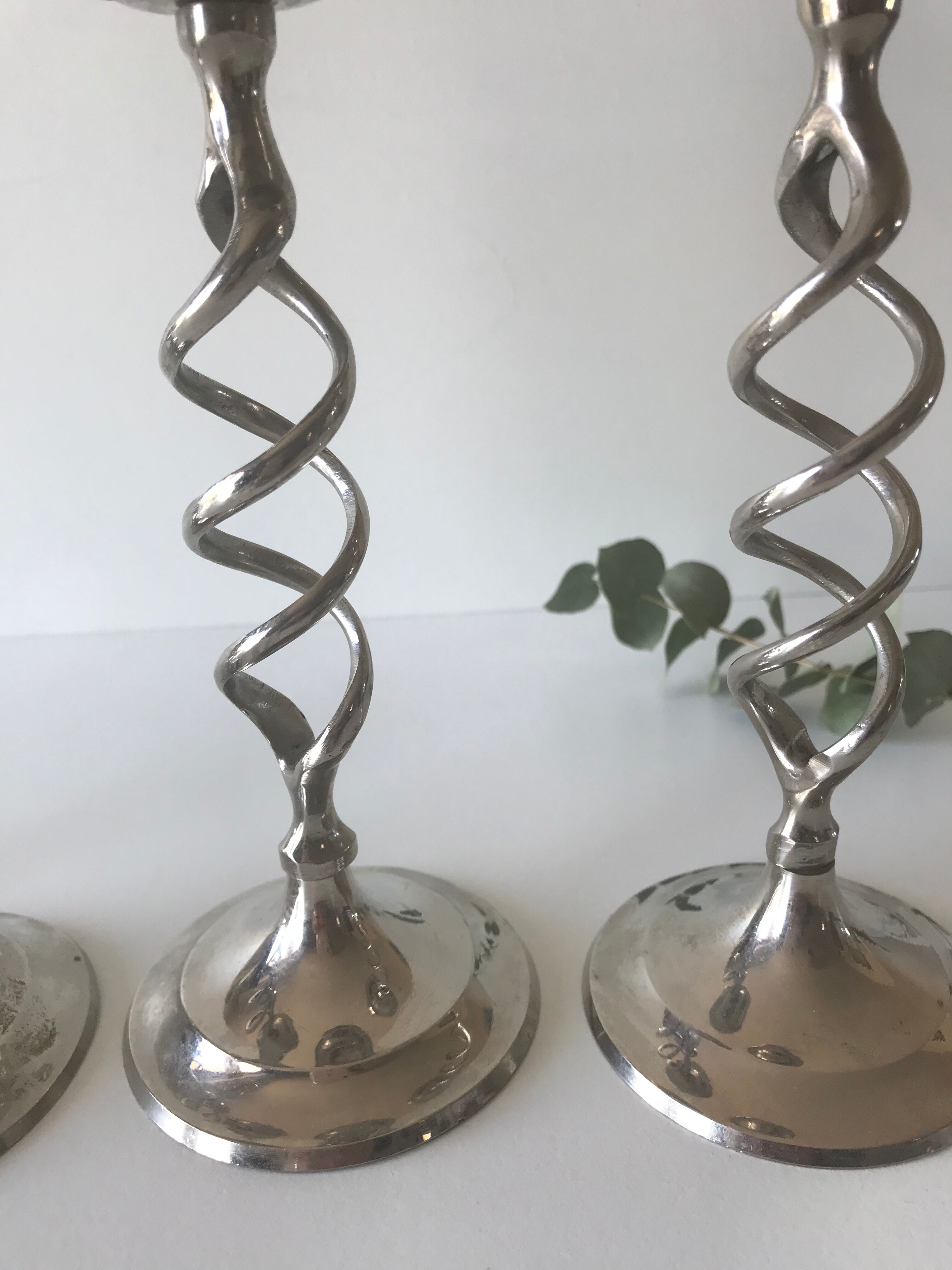 Four twisted silver candlesticks