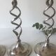 Four twisted silver candlesticks