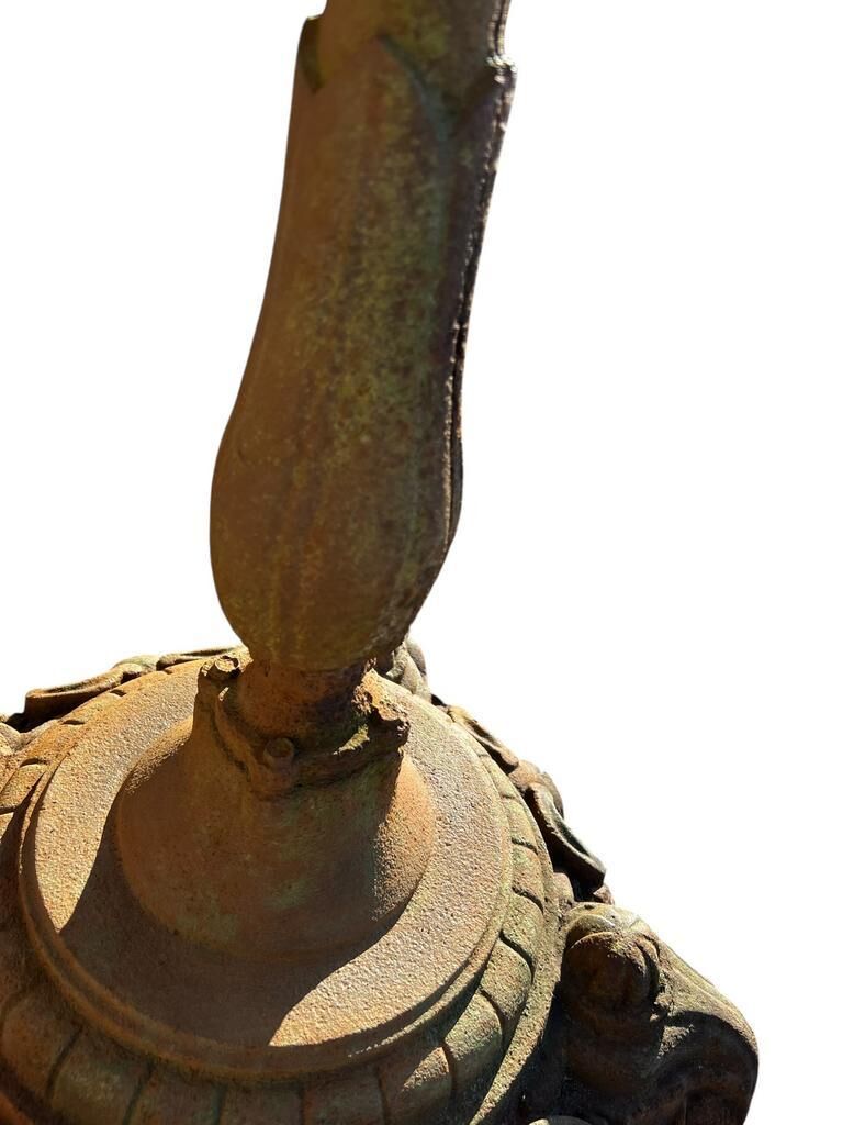 Antique cast iron garden table with decorative openwork top.