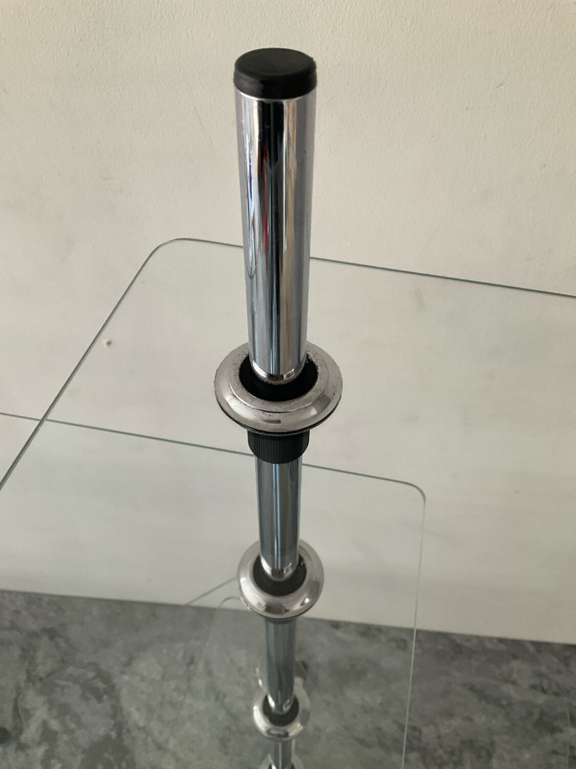 A pair of vintage side tables in glass and chrome metal.