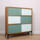 A vintage mid-century 3 tiered bookcase with glass sliding doors