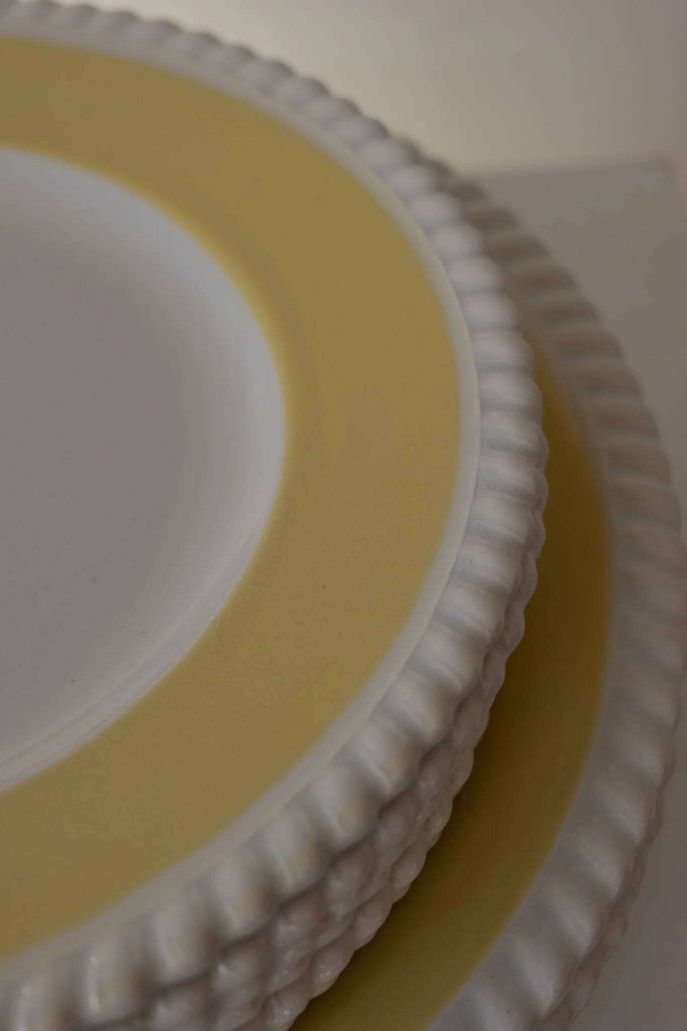 Vintage yellow butter ceramic dinnerware set with swirl border.