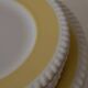 Vintage yellow butter ceramic dinnerware set with swirl border.