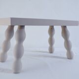 Small vintage wooden bench renovated in pinkish beige