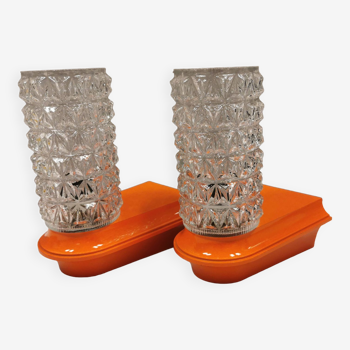 Bathroom lamps in a nice orange colour with a crystal glass shade and a base of hard thin plastic