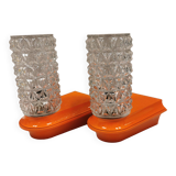 Bathroom lamps in a nice orange colour with a crystal glass shade and a base of hard thin plastic