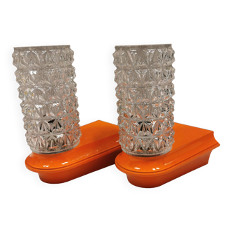 Bathroom lamps in a nice orange colour with a crystal glass shade and a base of hard thin plastic