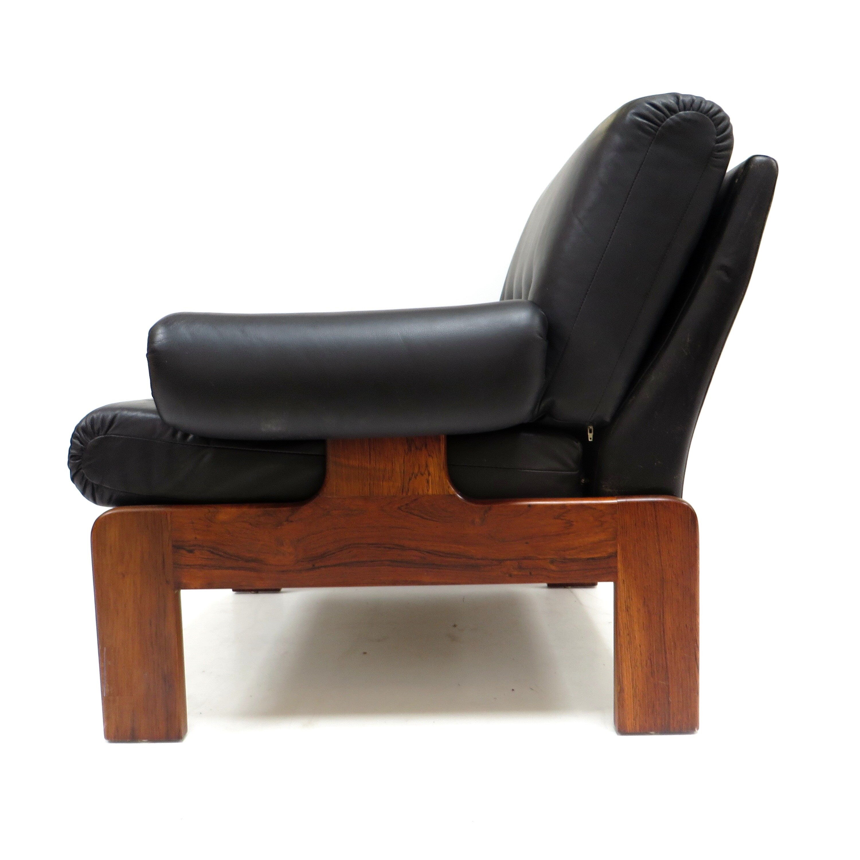 Vintage black leather armchair with solid rosewood frame made in the 1960s