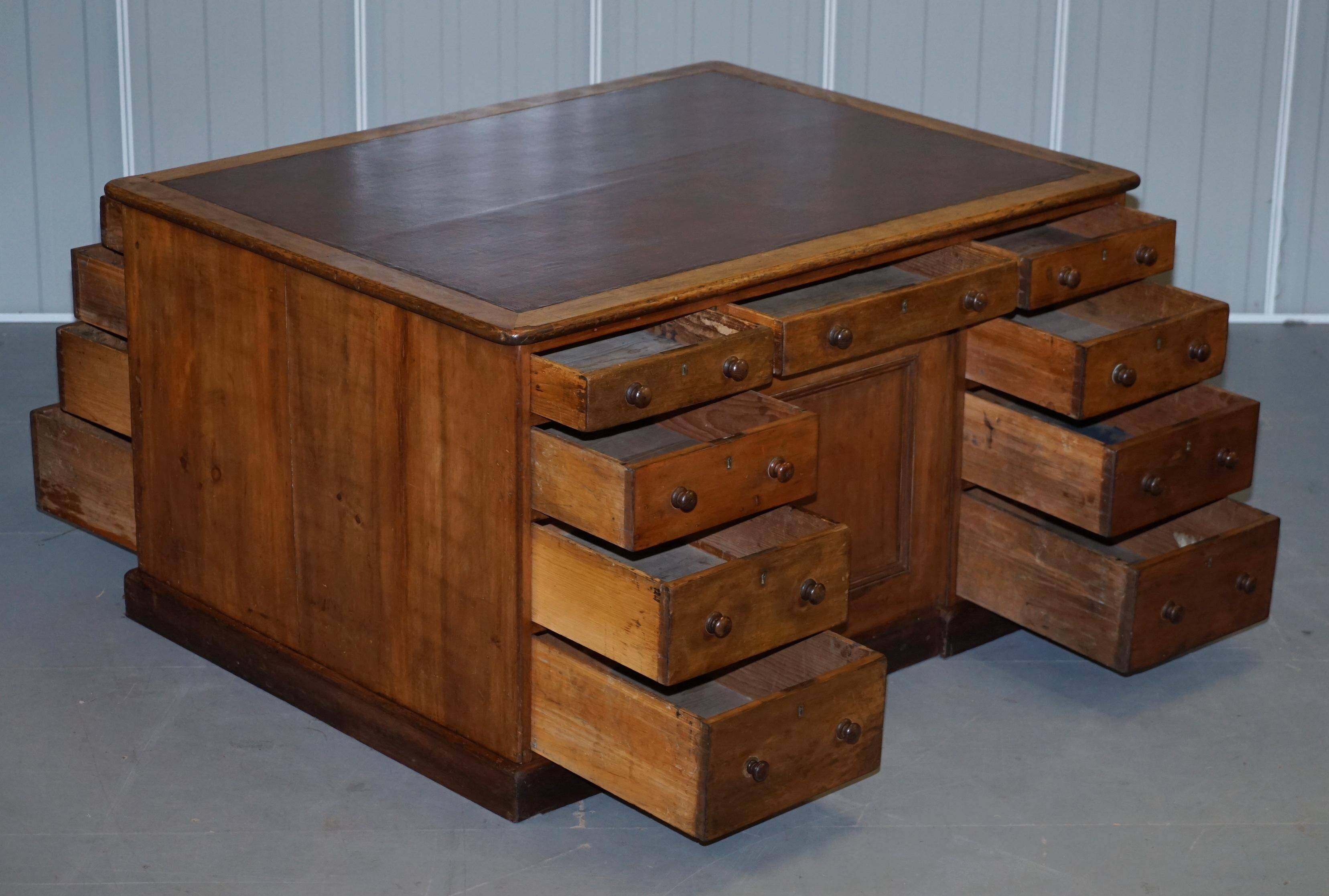 Antique Victorian oak kneehole desk with 18 double-sided drawers.