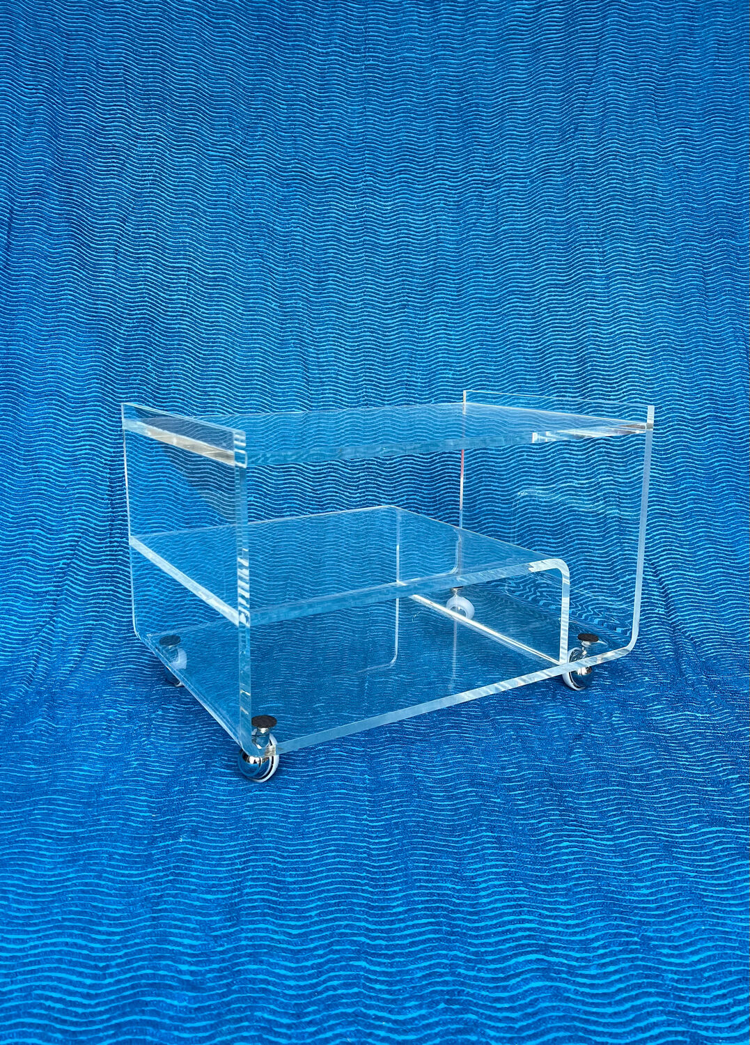 Translucent plexiglass storage drawer/cabinet on wheels.