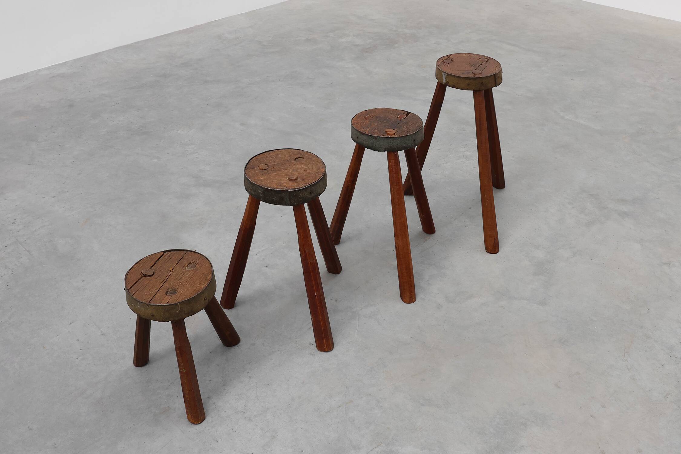 Brutalist French 1850s solid oak tripod stools with metal rim, set of 4
