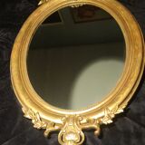 Ovoid mirror with double pediments gilded with leaf circa 1830, 105x66 cm