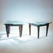 2 brutalist steel side tables with primitive  scene motifs etched glass