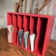 Vintage wooden magazine rack in red.