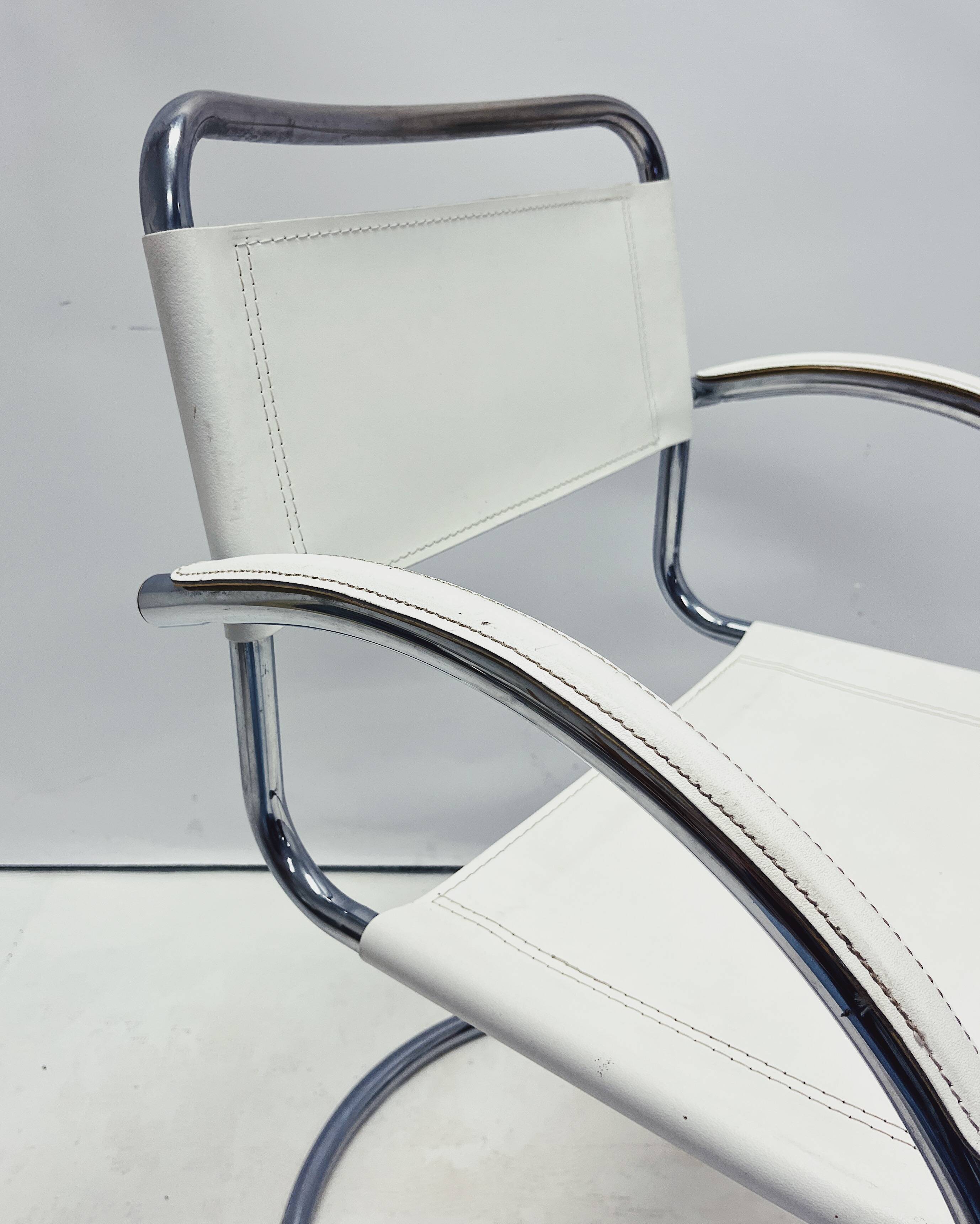 Vintage tubular frame chairs with white skai